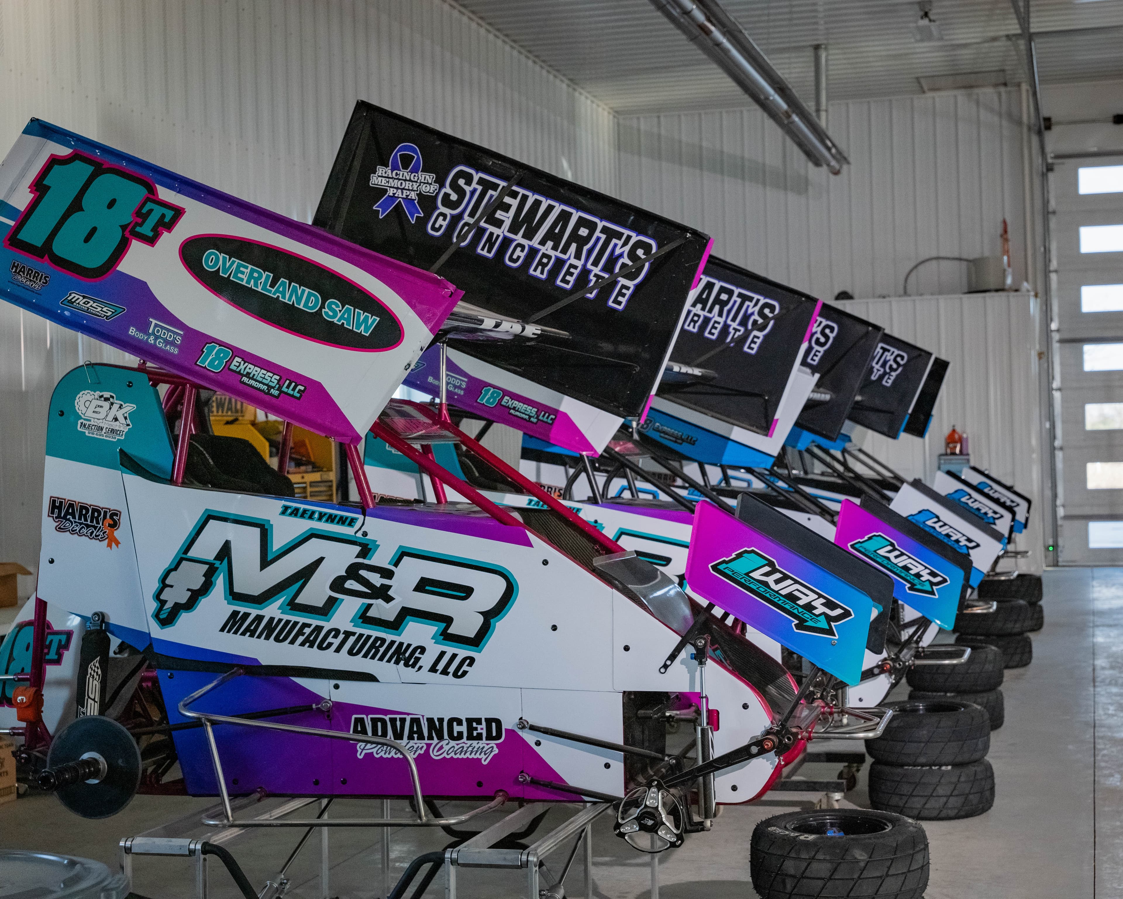 Photo of a row of Sprint Cars with M&R branding