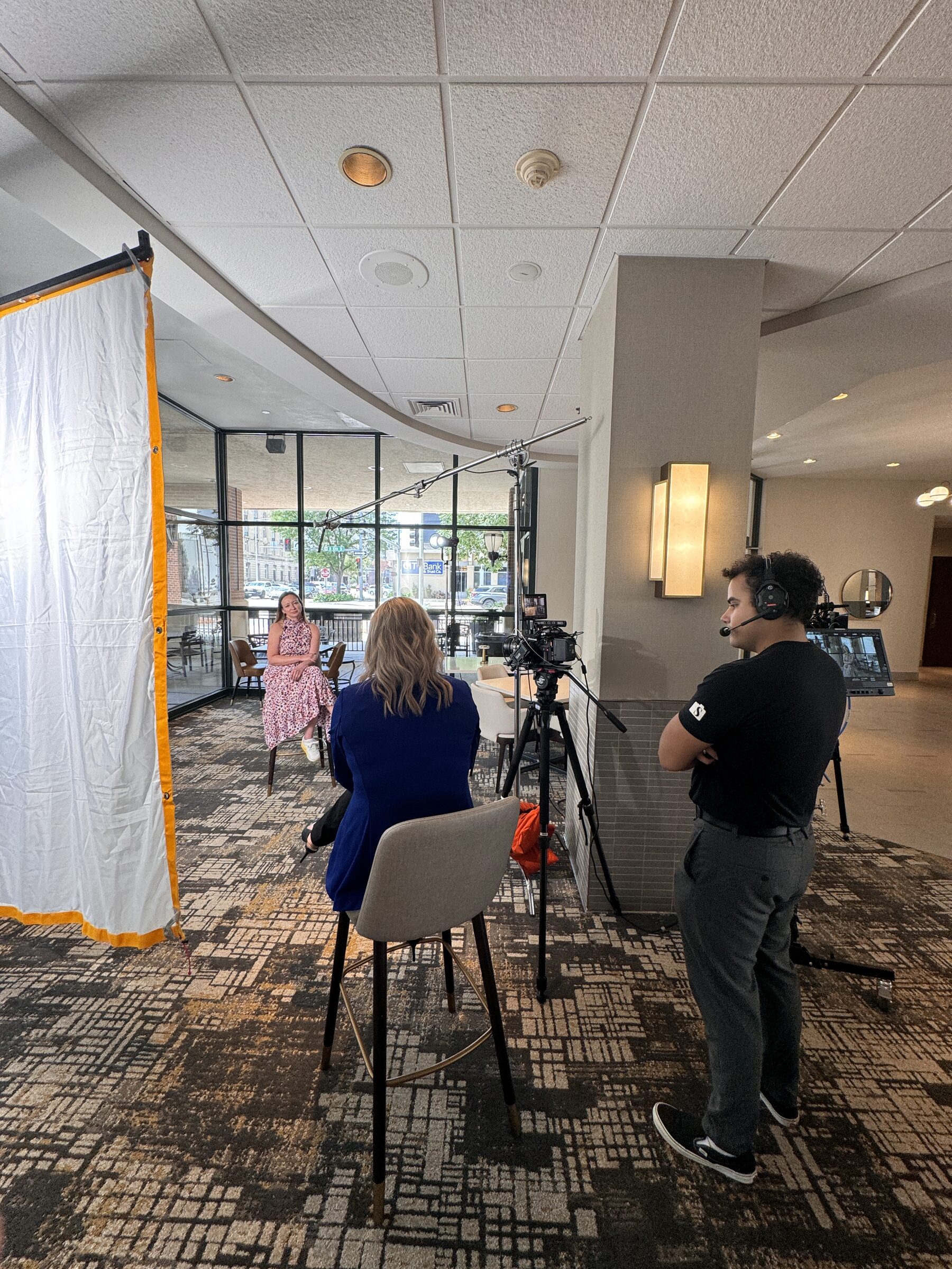 Behind-the-scenes commercial film production in a hotel lounge